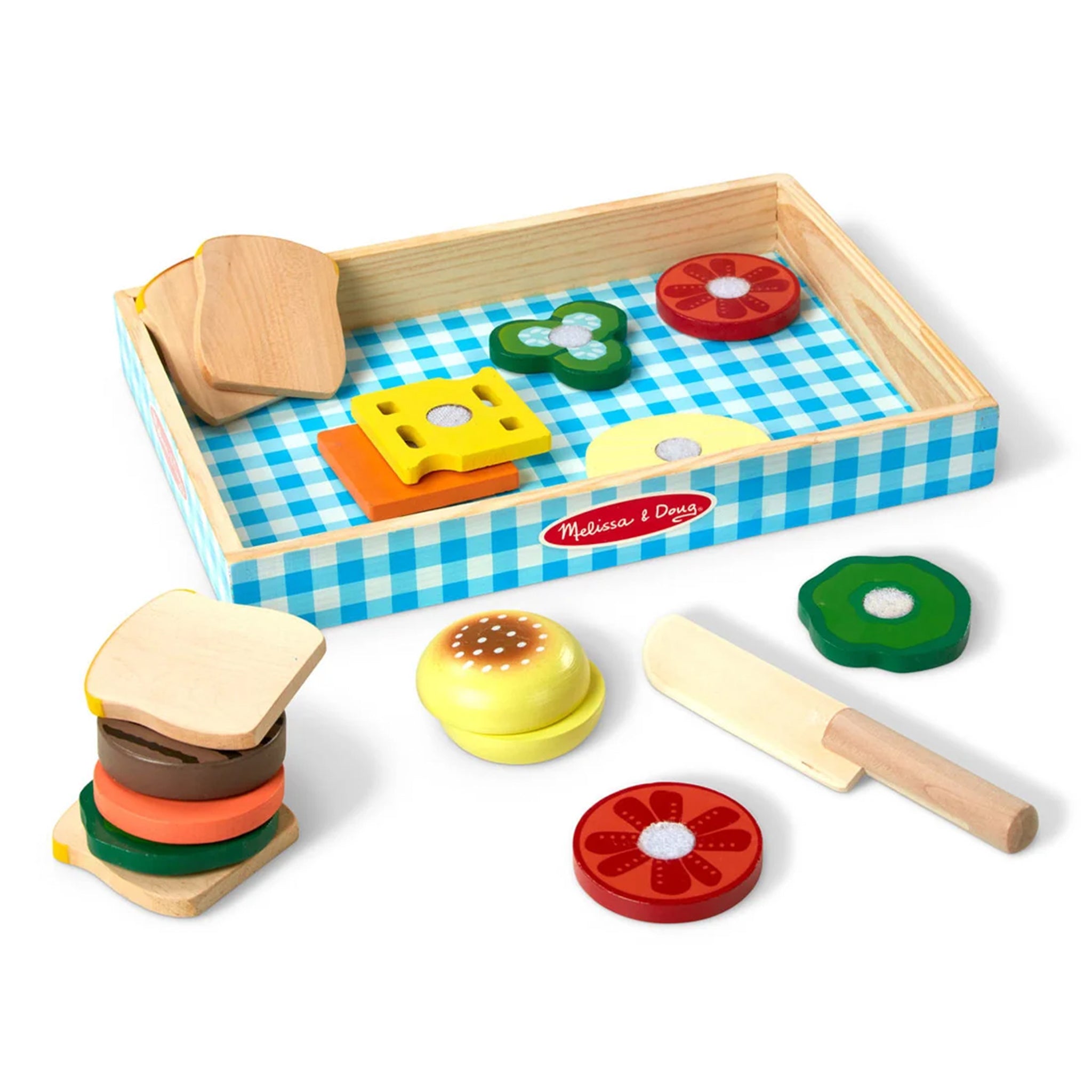 Wooden toy kitchen set with a checkered tray, colorful food pieces, and a spatula on a white background.