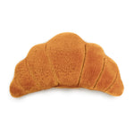 Plush toy shaped like a croissant on a white background