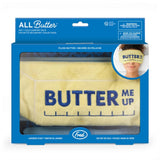 A boxed plush butter scarf from Fred, shown in its retail packaging. The product is a pale yellow towel-style scarf with 'BUTTER ME UP' embroidered in dark blue across the front.