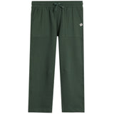 A pair of dark forest green scrub pants with an elastic waistband, drawstring, and side pockets, shown flat on a white background.
