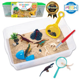 Dinosaur dig sensory bin toy set with a white plastic bin filled with sand, including dinosaur figures, a small volcano, rocks, a magnifying glass, a small brush, and a yellow scoop. The set is shown with its green storage container and two badges: a 'Sensory Bin Dinosaur Dig' package and a 'Toy Insider 2022 Winner' badge.