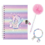 A pastel rainbow spiral notebook with a unicorn illustration, shown with a pink pom-pom pen, a beaded bracelet, and a small keychain on a white background.
