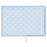 A light blue journal featuring a white trellis pattern and a small white pull tab at the bottom center, shown against a plain white background.