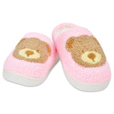 Pair of pink slippers with bear face design on a white background