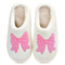 White slippers with pink bows on a white background