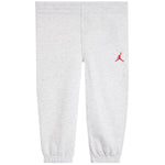 Light heather gray sweatpants with an elastic waistband and cuffs, featuring a small red Jumpman logo on the left hip.