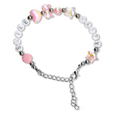 A beaded charm bracelet on a white background, featuring silver-toned round beads spelling 'SMILE', white round beads spelling 'HAPPY', iridescent pink heart and star beads, a pink patterned heart bead, and a silver chain extender.