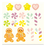 A sheet of colorful candy-themed stickers featuring yellow stars, pink hearts, candy canes, peppermint swirls, and gingerbread people on a cream background.