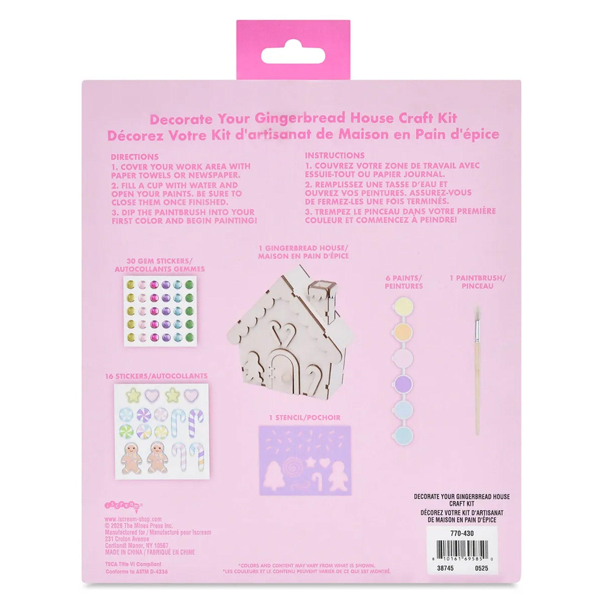 Back of a gingerbread house craft kit package in pink, showing included items such as stickers, wooden gingerbread house pieces, paintbrush, and printed instructions in English and French.
