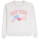 A light heather gray crewneck sweatshirt featuring a 'NEW YORK' graphic in pink outlined letters, decorated with a light blue heart, a pink heart, and two pink-outlined stars on the front.