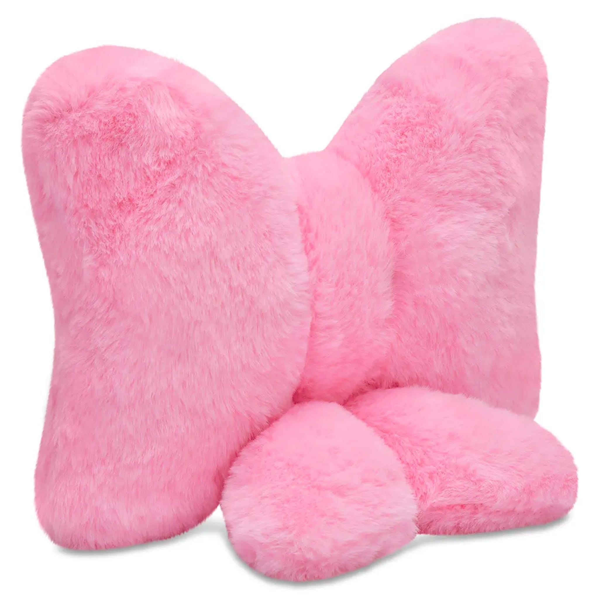 A pink plush bow-shaped pillow with a soft, fuzzy texture, shown against a plain white background.