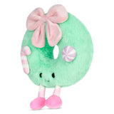 A mint green plush donut toy with a large pink bow, pink and white striped candy accents, and pink feet, shown on a plain white background.