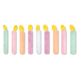 A set of nine plush candle-shaped items in assorted pastel colors with yellow flame tops, arranged in a row on a plain white background.