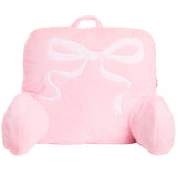 A pink plush baby support pillow shaped like a gift box with a white embroidered bow on the front, set against a plain white background.