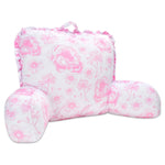 A pink and white floral lounge pillow with ruffled edges and a top carrying handle, shown on a plain white background.