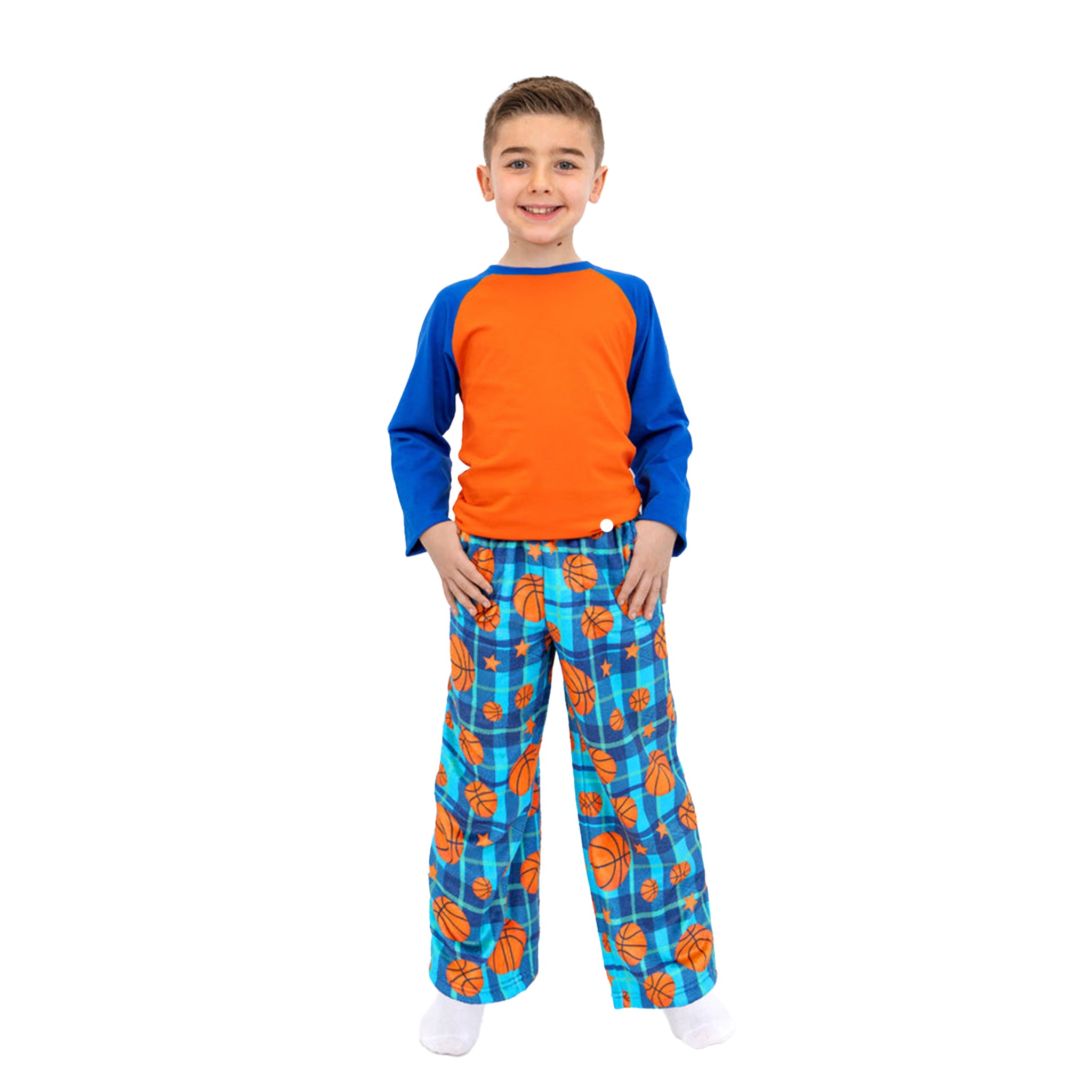 A young boy modeling a two-piece pajama set featuring a bright orange and blue raglan t-shirt and matching blue plaid pants with an orange basketball pattern, set against a plain white background.