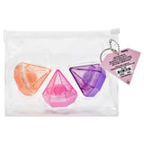 Three translucent gem-shaped lip balms in orange, pink, and purple, packaged inside a clear zippered plastic pouch with a pink product tag attached.