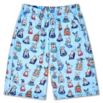 Light blue shorts featuring an all-over cartoon dog print in navy, red, white, and orange, displayed flat against a white background.
