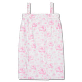 A white spa wrap with a pink floral pattern, featuring thin shoulder straps and a front closure, shown against a plain white background.