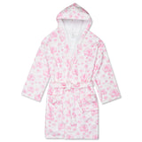 A white hooded bathrobe with a pink floral pattern, featuring a tie belt and front pockets, shown against a plain white background.