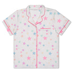 A short-sleeve pajama shirt with a white base, decorated with a pattern of pastel pink, blue, and yellow stars, and finished with pink piping on the collar, placket, and sleeve cuffs.