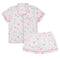 A two-piece children's pajama set featuring a short-sleeve button-front top and matching shorts in white, decorated with a pastel star pattern in pink, blue, and yellow, finished with pink piping trim.