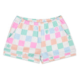 A pair of kids' pajama shorts featuring a pastel multicolor checkered pattern with pink, mint green, peach, and light blue squares on a white base. The shorts have an elastic waistband and side pockets, decorated with small pastel icons including stars, hearts, smiley faces, and a crescent moon.
