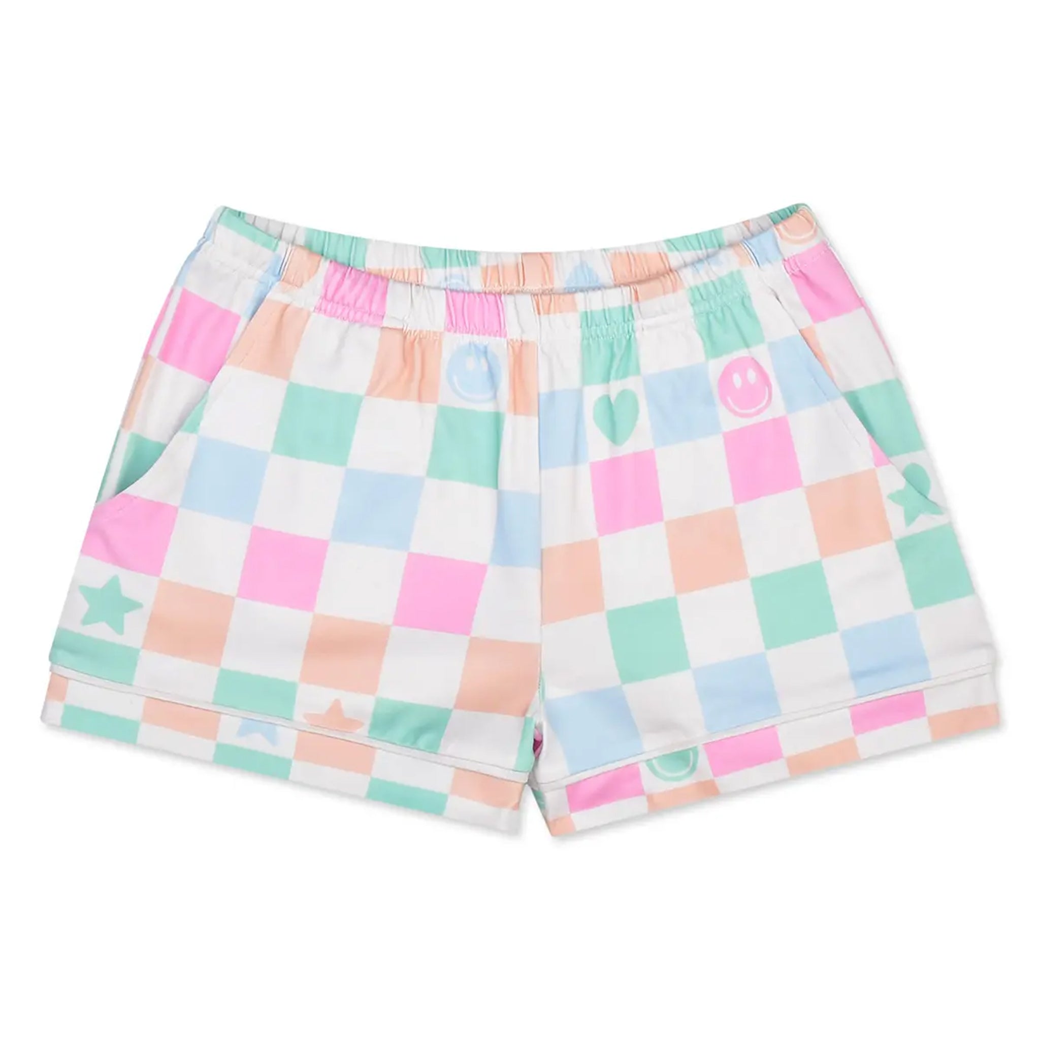 A pair of kids' pajama shorts featuring a pastel multicolor checkered pattern with pink, mint green, peach, and light blue squares on a white base. The shorts have an elastic waistband and side pockets, decorated with small pastel icons including stars, hearts, smiley faces, and a crescent moon.