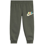 An olive green Nike joggers with  colorful 'NIKE' lettering on the pant, a white swoosh logo
