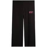 Black wide-leg sweatpants featuring a pink embroidered 'NYC' graphic on the upper left thigh, displayed against a solid white background.