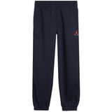 Navy sweatpants with an elastic waistband and cuffs, featuring a small red and white Jordan logo on the left thigh.