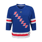 A blue New York Rangers hockey jersey with 'RANGERS' written diagonally in red and white on the front, featuring red and white stripes on the sleeves and hem.