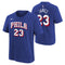 A royal blue short-sleeve t-shirt shown from both front and back. The front features 'PHILA' and '23' in white block letters with red outlines, and a small white Nike swoosh on the left chest.