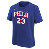 A royal blue short-sleeve t-shirt featuring 'PHILA 23' in white varsity-style lettering with red and black outlines on the front, and a small white Nike swoosh on the upper left chest.