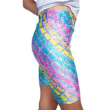 Colorful patterned girls bike shorts worn by a person on a white background