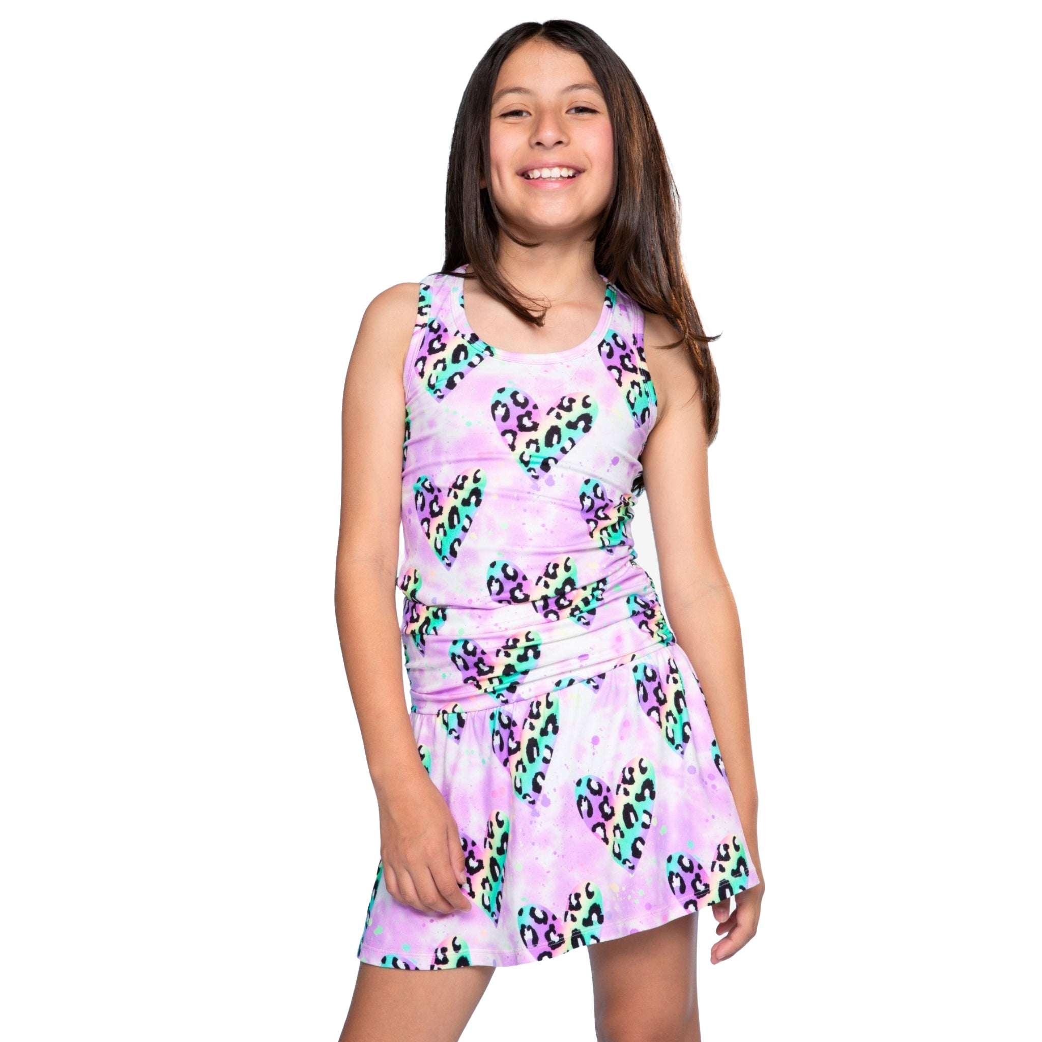 Girl wearing skort with colorful leopard print and hearts and matching tank on a white background