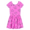 A pink short-sleeve dress with white speckles, featuring a playful all-over print of black line drawings including stars, hearts, bows, rainbows, and peace signs, set against a plain white background.