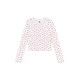 A long-sleeve crop top with a white base and a small pink floral pattern, laid flat against a solid white background.