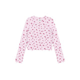 A light pink long-sleeve crop top with an all-over small red cherry print, displayed flat against a solid white background.