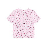 A light pink short-sleeve baby t-shirt with a small red cherry print, laid flat against a solid white background.