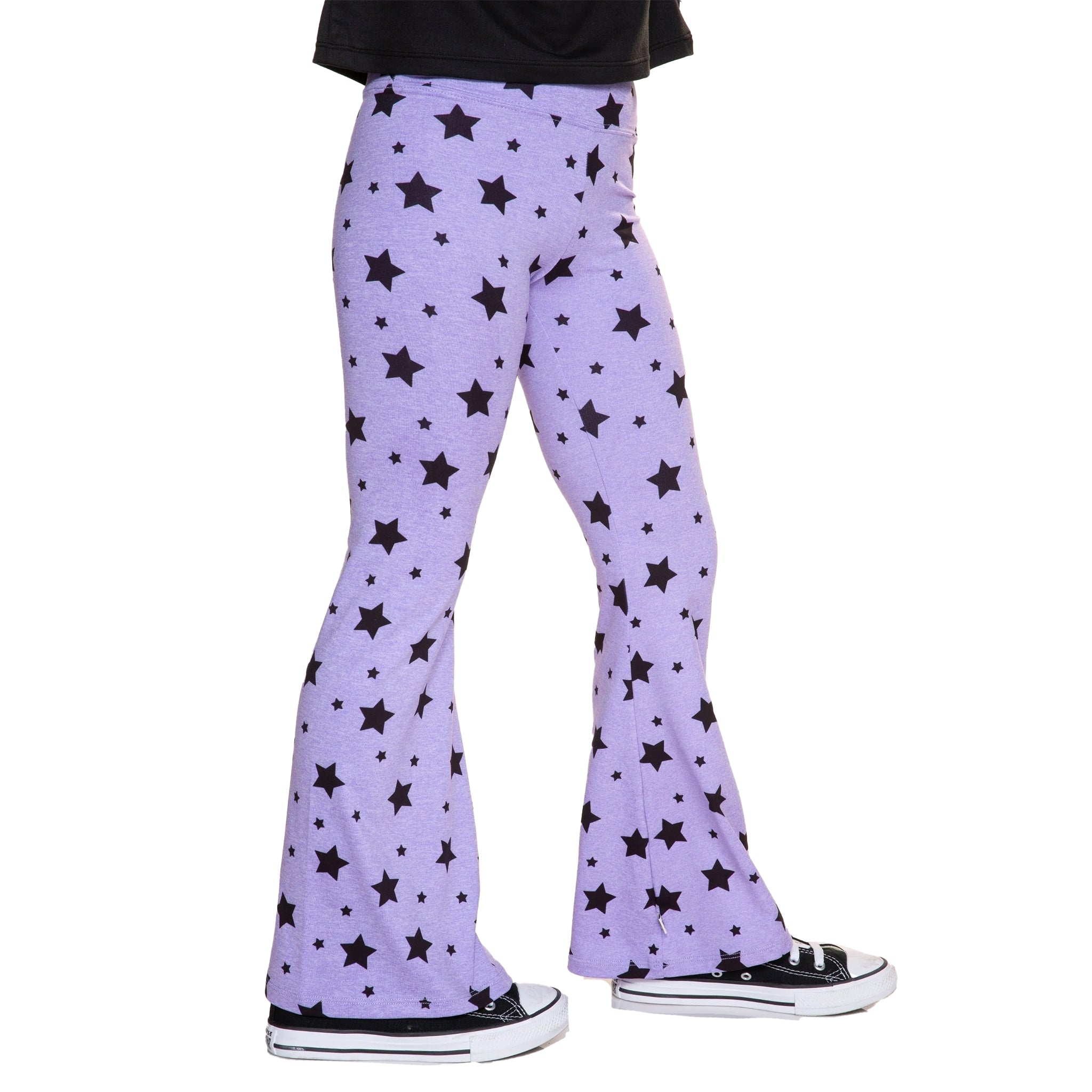 Purple flared pants with a black star pattern, shown on a model from the waist down wearing black sneakers against a white background.