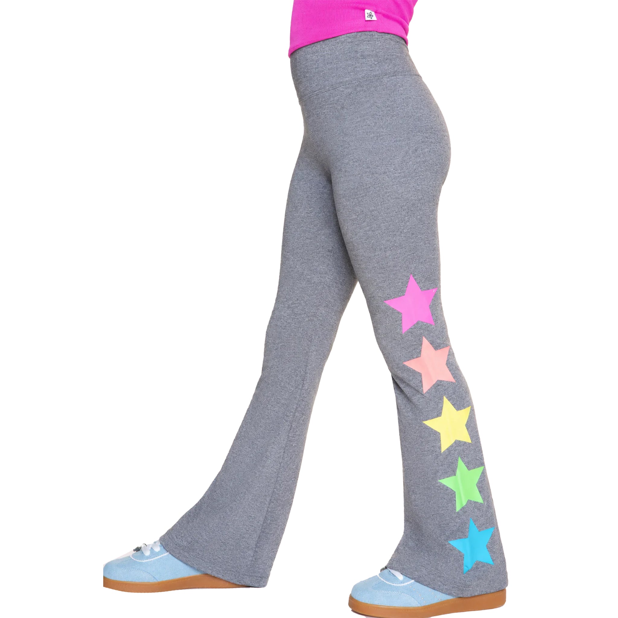 Gray flared leggings with a vertical row of colorful stars in pink, peach, yellow, green, and blue down the outer leg, shown on a model from the waist down wearing light blue sneakers.