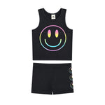 A two-piece kids' outfit set consisting of a black sleeveless tank top and matching shorts. The tank top features a large rainbow-gradient smiley face graphic on the front, and the matching shorts feature a vertical stack of smaller smiley faces on the side.
