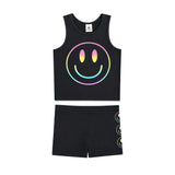 A two-piece kids' outfit set consisting of a black sleeveless tank top and matching shorts. The tank top features a large rainbow-gradient smiley face graphic on the front, and the matching shorts feature a vertical stack of smaller smiley faces on the side.