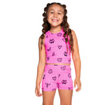 Bright pink two-piece athletic set with black doodle prints, photographed against a solid white background.