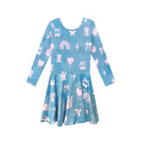 A long-sleeve blue dress with a pink and white whimsical pattern of rainbows, stars, bows, and teddy bears, shown against a plain white background.