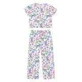 A two-piece children's pajama set featuring a short-sleeve top and matching pants, both in a light pink color with a colorful pattern of cherries, bows, stars, and hearts, displayed on a solid white background.