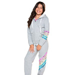A young girl wearing a light gray zip-up hoodie and matching sweatpants with colorful sequined stripes on the sleeves and legs, posed against a solid white background.