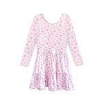 A long-sleeve babydoll dress with a tiered skirt, featuring a light pink base with a dense all-over floral print in pink, green, and white.
