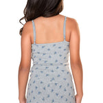 Rear view of a woman wearing a heather gray camisole dress with a small blue floral pattern, set against a plain white background.
